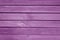 Old grungy wooden planks background in purple color