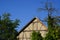 Old half-timbered barns with climbing plants on the wall in the warm evening light. Not a single cloud can be seen in the sky