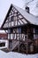 Old half-timbered house, historic peasant home, snowy winter season scene