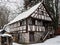 Old half-timbered house^, historic peasant home, winter season landscape