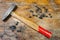 The old hammer and finishing nails on a table in a workshop