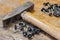 The old hammer and finishing nails on a table in a workshop