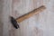 Old hammer tool. Hammer tool on blurred wooden background.