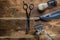Old hand hairdressing tools. Manual clipper, hairdressing scissors, straight razor, brush for shaving foam. on brown weathered