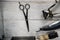Old hand hairdressing tools. Manual clipper, hairdressing scissors, straight razor, brush for shaving foam. on white weathered