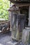 An old hand Vice mounted on a wooden plinth in an industrial railway yard setting