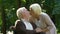 Old handicapped man hugging and kissing his beautiful wife, pastime together