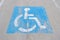 Old handicapped parking sign painted on concrete