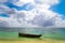 Old handmade african  dhow fishing wooden boat anchored in the ocean in sunny weather