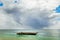 Old handmade african  dhow fishing wooden boat anchored in the ocean in sunny weather