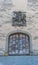 Old handmade medieval wooden gate with a commemorative town seal above in an idyllic small European village