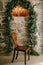 An old handmade wooden chair. Vintage home-made furniture. A chair against the backdrop of an arch of leaves and a stone