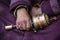 Old hands of a Tibetan woman holding prayer buddhist wheel at a Hemis monastery, Leh district, Ladakh, Jammu and Kashmir, north In