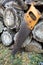 Old handsaw resting on a pile of wooden lumber. Rural lifestyle concept