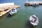 The old harbor on the quiet Greek island of Kasos. Traditional fishing boats moored in sheltered waters.  A peaceful, untroubled