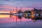 Old harbor with sail boat against sunset in Bergen. UNESCO World Heritage Site, Norway