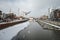 Old harbour canal with marina in ice and snow during winter in Old Town of Gdansk Poland. Old town in the background.