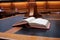 old hard cover book sitting at an old traditional timber reading desk under a glass lamp in an old state library in Melbourne,