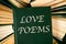Old hardcover books with book Love Poems on top