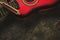 Old harmonica and a red guitar on a dark abstract background. Musical instrument