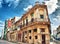 Old Havana colonial building with balconies against blue sky