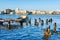 The Old Havana skyline and an old pier with fishing boats on the Bay of Havana