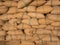 Old hemp sacks containing rice placed stacked.