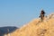 Old hiker climbing on a mountain in abruzzo. Trekking during summer in the natural park in the center of Italy. Trekker wears camo