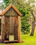 Old Historic Australian Toilet, Outhouse, Dunny on Green Grass.