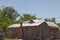 Old historic brown home boarded up windows tin roof