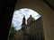 Old Historic Church with Cloudy Sky Seen Through Passage Archway