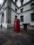 Old historic classic traditional typical public red telephone box kiosk booth in London England Great Britain UK