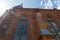 Old historic Gothic Catholic Cathedral made of red brick. View of the Cathedral from below against the background of the sun and