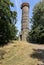 Old historic outlook tower on the grassy hill