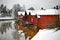 Old historic Porvoo, Finland. Red coloured vintage wooden barns storage houses on the riverside with snow in winter