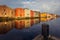 Old historic storehouses along the river Nidelva with colorful painted facades in Trondheim on beautiful winter day