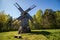 Old historic wooden windmill in Estonia, blue sky, green trees in the background