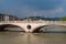 Old historical bridge Ponte della Vittoria across the Adige River in the center of Verona. In the background Santuario