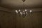 old historical eight-armed chandelier. silver single with spruce cone