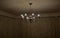old historical eight-armed chandelier. silver single with spruce cone