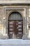 Old historical gate with wooden door and artistic decor. Wroclaw, Poland