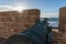 Old Historical portugese Heavy Classical Metal Cannons In a Fortress Sunset Time at the seaside view From Fort on