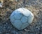 Old holey deflated soccer ball,