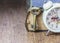 The old holy bible with metal key and alarm clock on wooden background