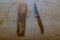 An old homemade knife and a whetstone. Sharpen a knife with a sharpening stone.