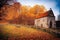 Old house building with window over beautiful autumn nature background. Historic architectural ruins surrounded last