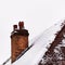 Old house clay brick chimney in winter covered with snow