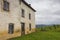 Old house with closed window shutters in french village. Ancient abandoned farm in mountains. Rural landscape.