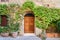 Old house decorated with flowers in Monteriggioni, Tuscany, Italy