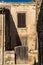 Old house entrance with a wooden door and window at the medieval town of Chateau de Baux